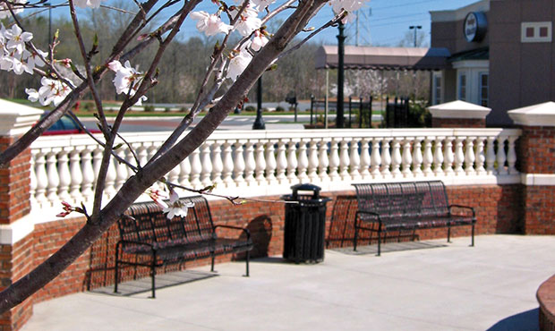 Midtown Benches and a matching receptacle with blossoms in the foreground
