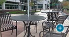 Courtyard Table and Chair Sets with umbrellas on an outdoor patio