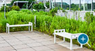 This rooftop green space includes a pair of flat Liberty benches
