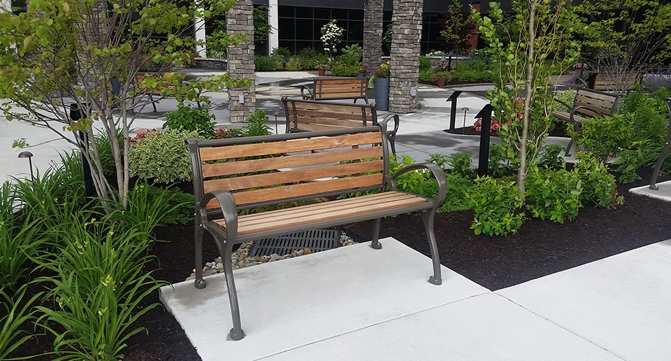Schenley Benches with Back and wooden slats provide seating for an office park