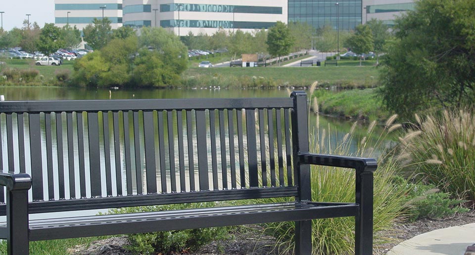 Reading Bench with Back installed on a walking track near an office park