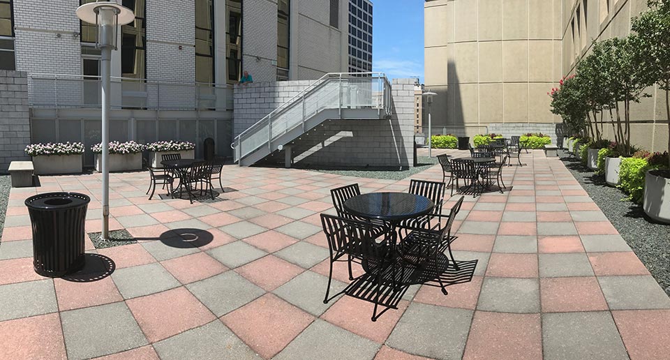 Courtyard Table Sets and Harmony Litter Receptacles provide outdoor eating options