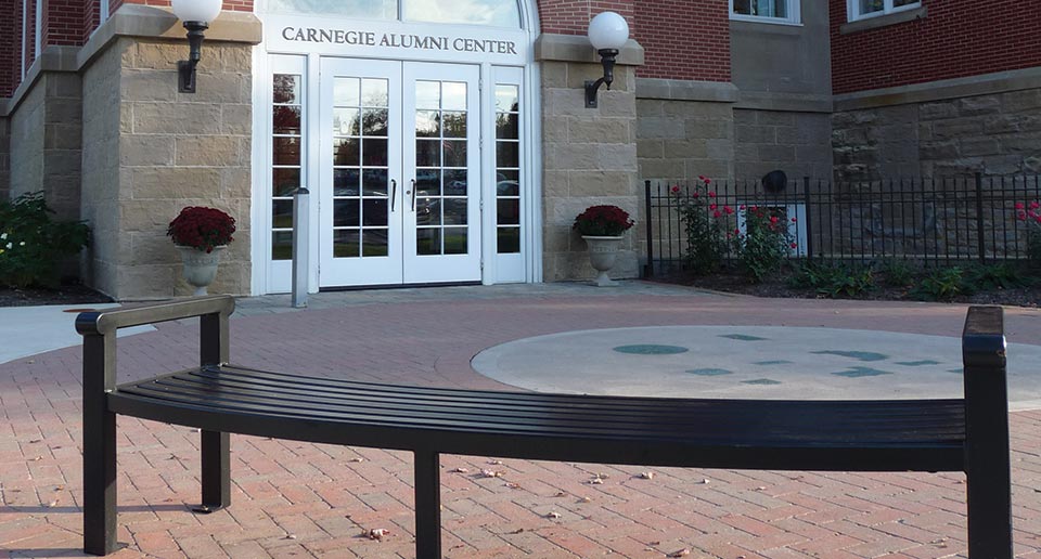 Curved Flat Reading Bench outside of an Alumni Building