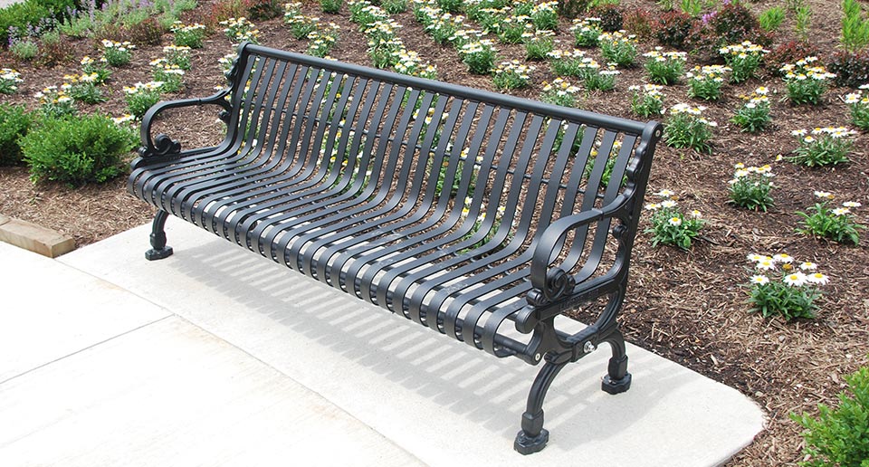 Lamplighter Bench with Back set amidst a landscaped garden environment