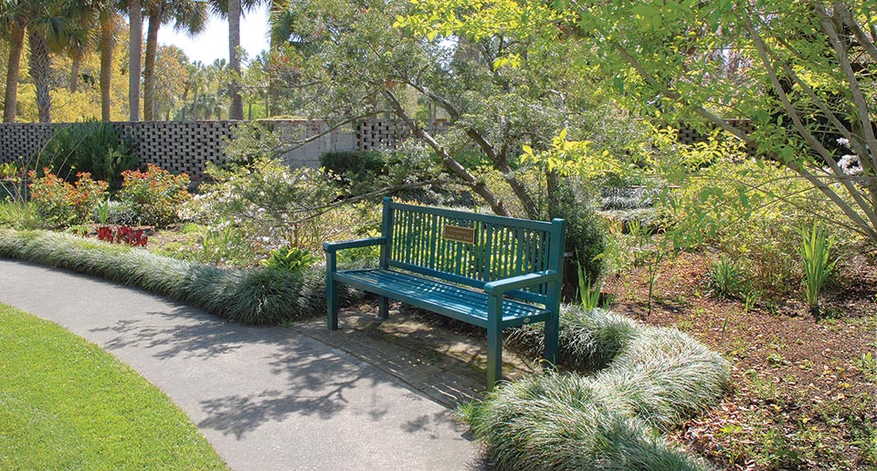 Reading Bench with Back and plaque installed in a botanical garden