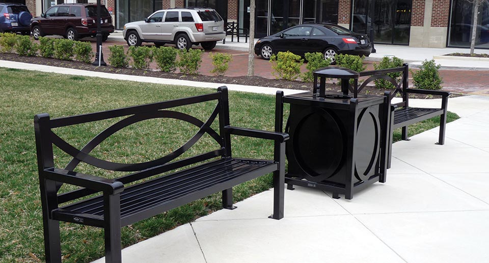 Yuma Benches with Back and coordinating Litter Receptacle in a commercial retail space